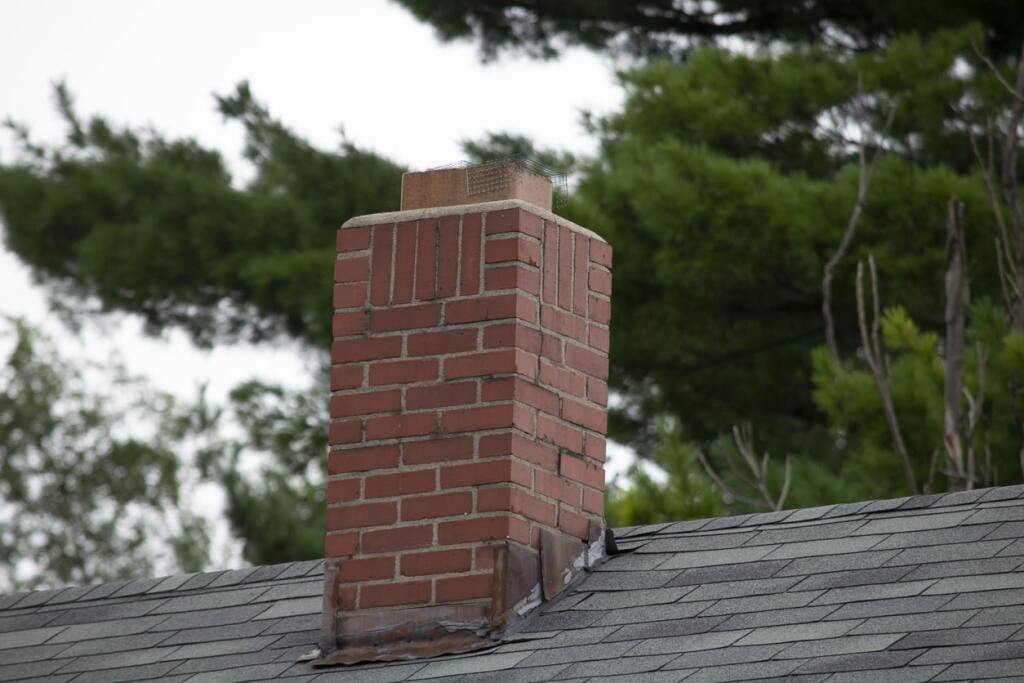 Brick chimney on a sloped roof