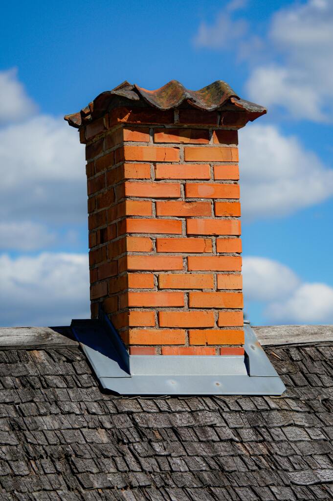 Brick chimney against blue sky