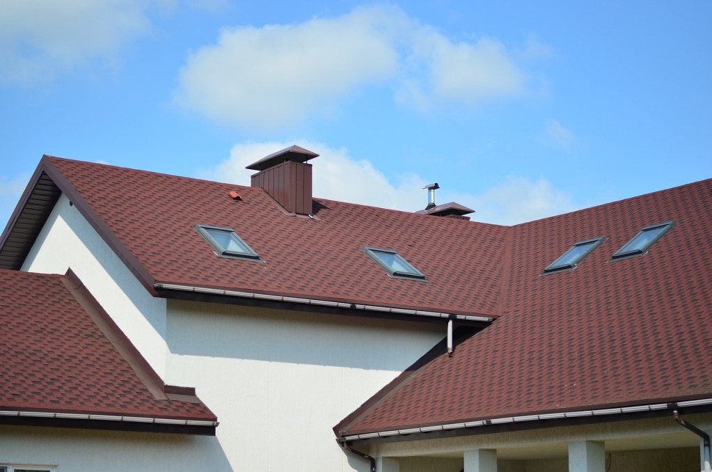 Modern house with red roof shingles