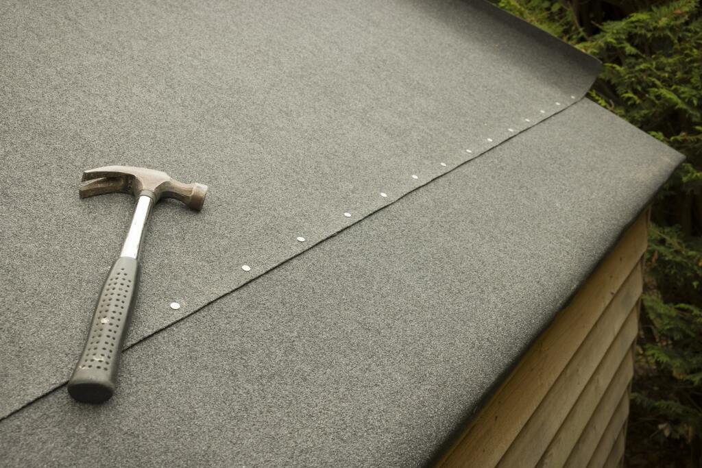 Hammer on gray roofing material