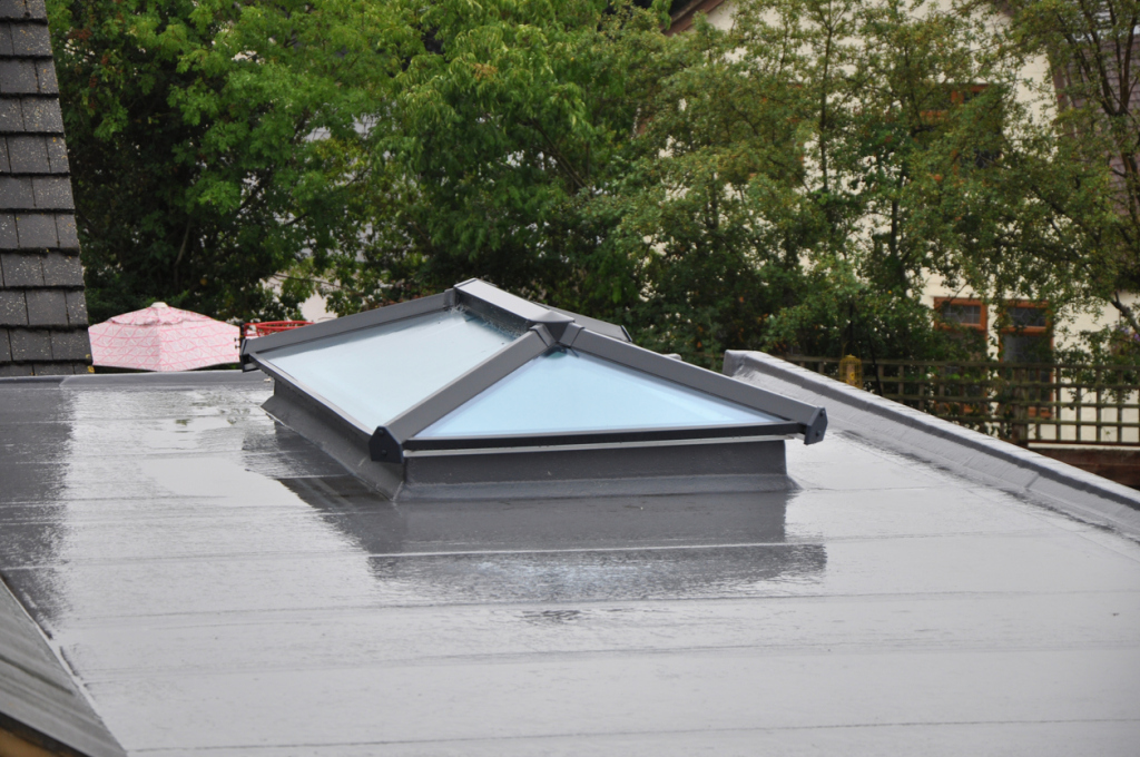 Flat roof with skylight, rainy day.