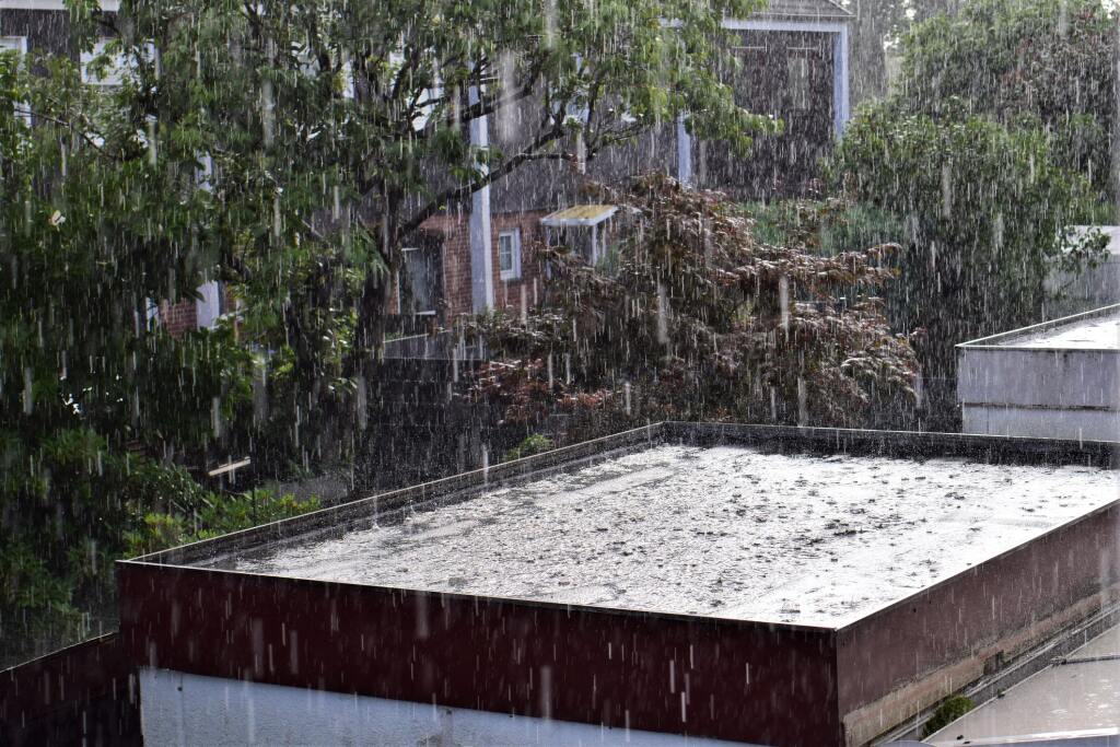 Rain pouring on a flat roof.