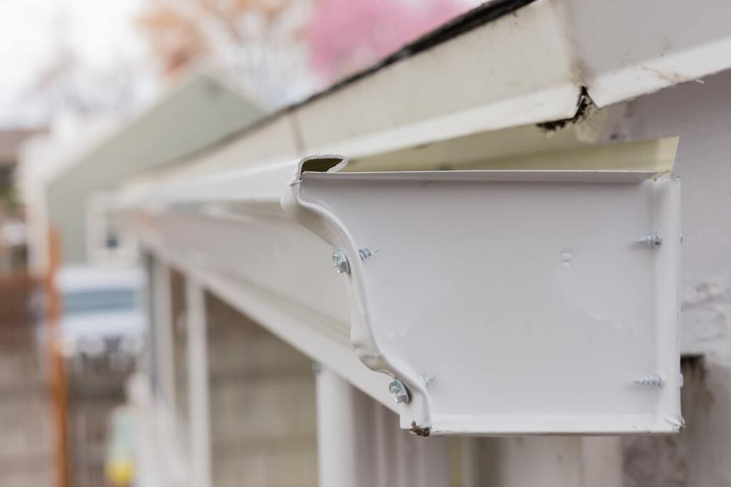 White gutter end cap on roof