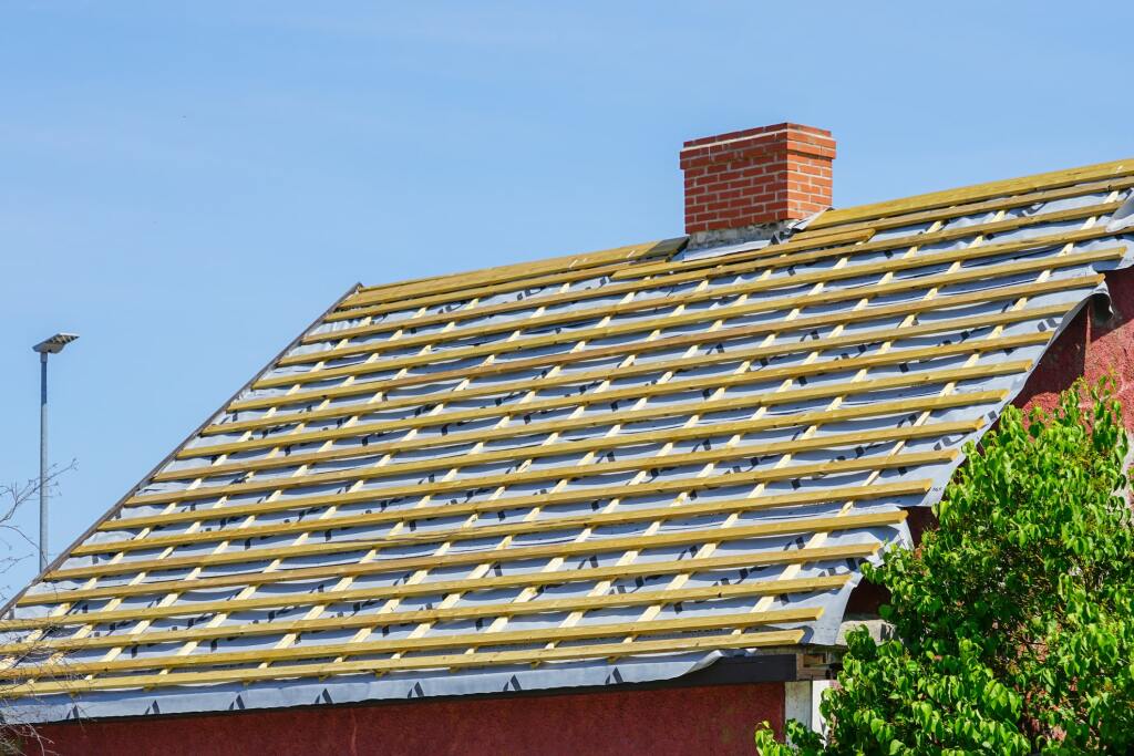 Roof underlayment installation on house