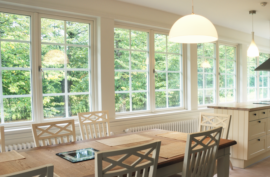 Bright kitchen dining area with large windows and natural light.