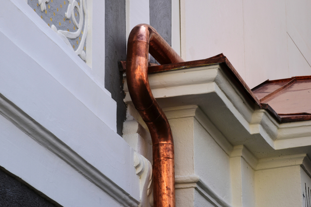 Copper pipe on building corner