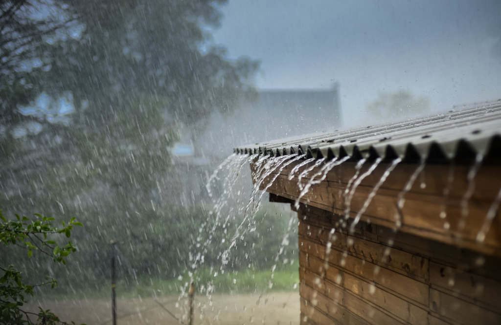 Heavy rain pouring off roof