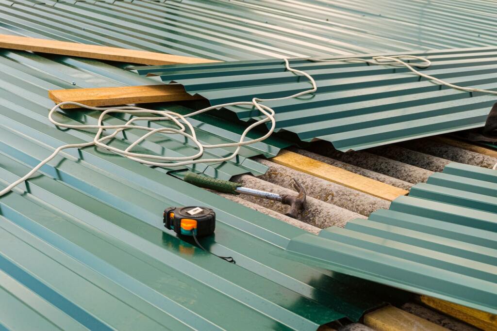 Green metal roof installation in progress