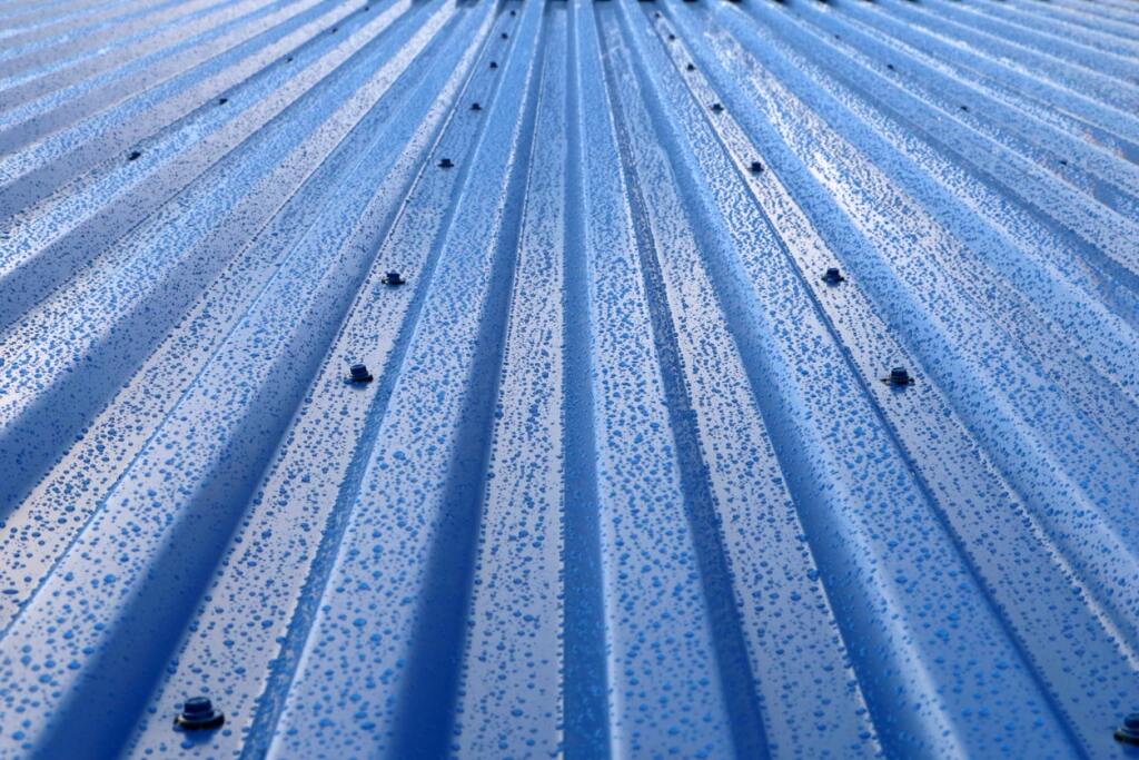 Blue metal roof with raindrops