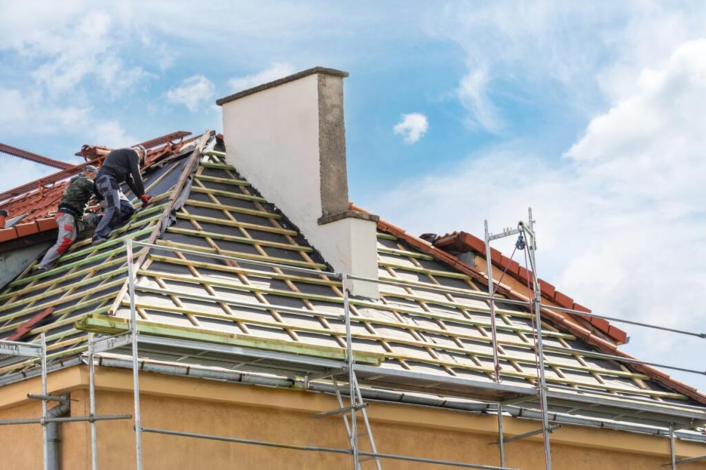 Workers replacing a residential roof.