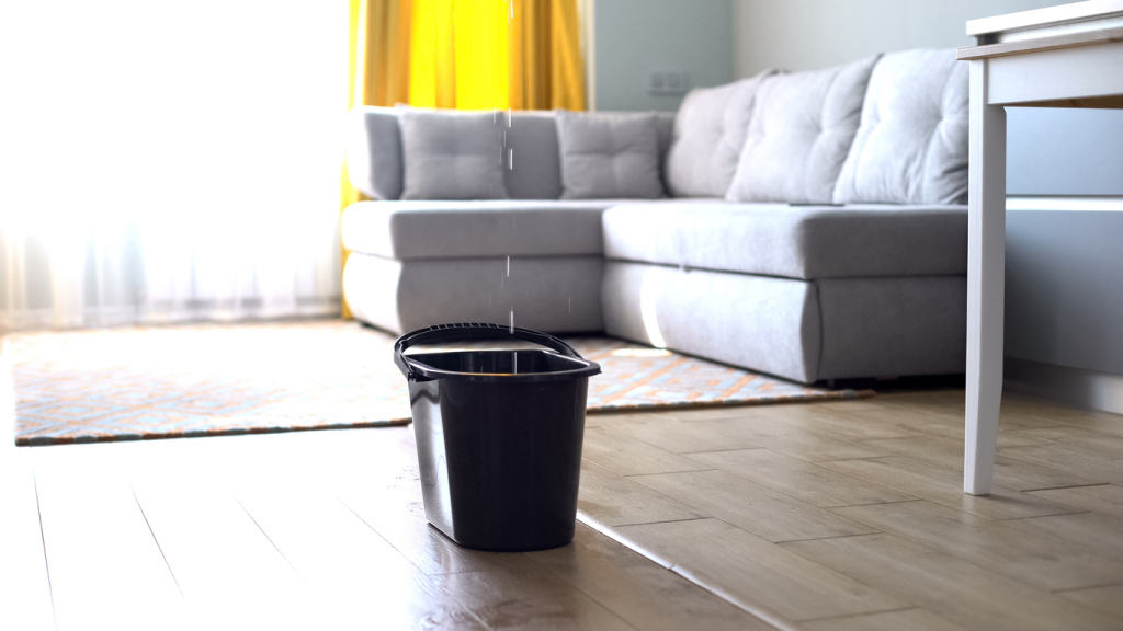 Water dripping into bucket indoors