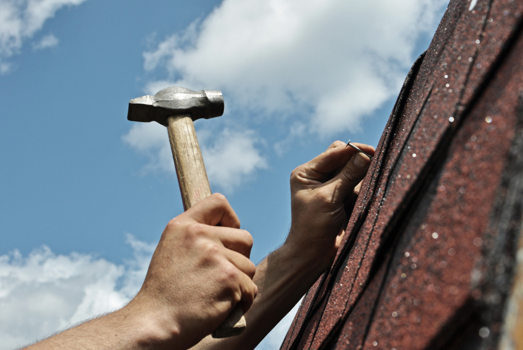 Hammering nails into a roof
