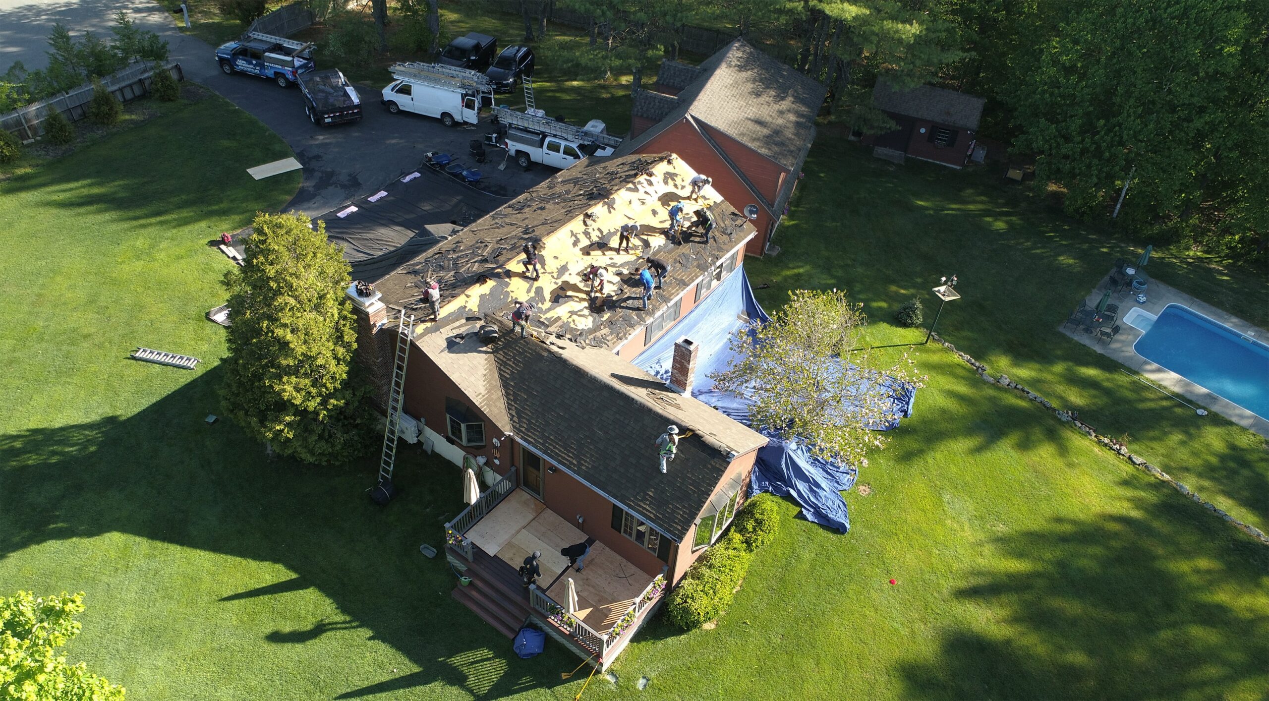Workers replacing roof on house