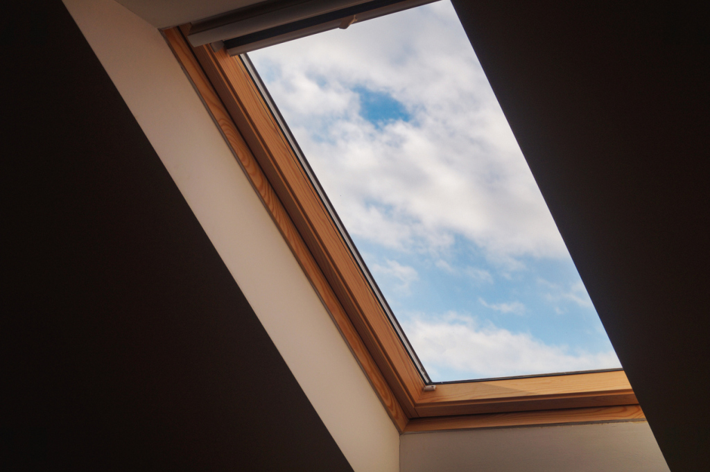 Wooden skylight revealing cloudy sky