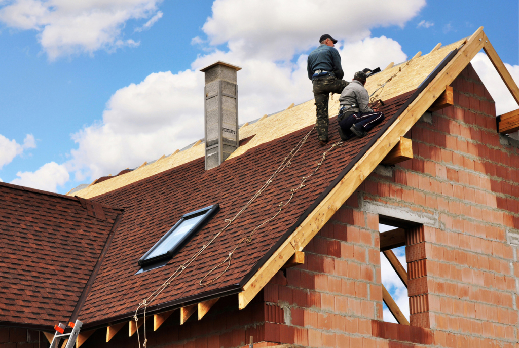 Workers installing roof with skylight
